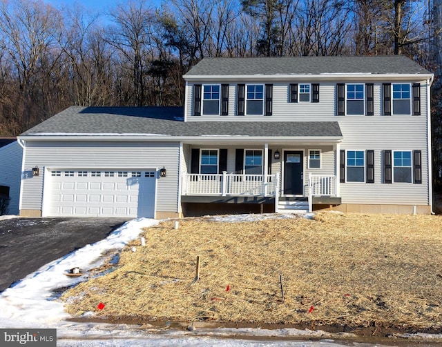 view of front of home with a porch and a garage