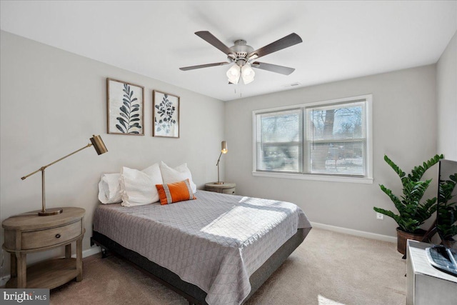 bedroom featuring light colored carpet and ceiling fan