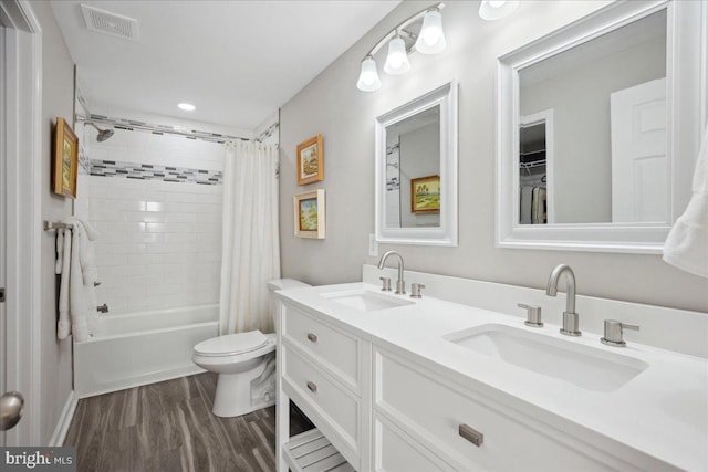 full bathroom with shower / tub combo, vanity, wood-type flooring, and toilet