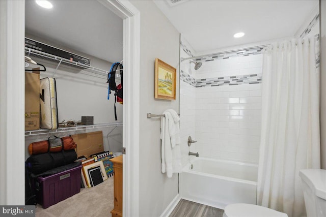 bathroom featuring shower / tub combo with curtain and toilet