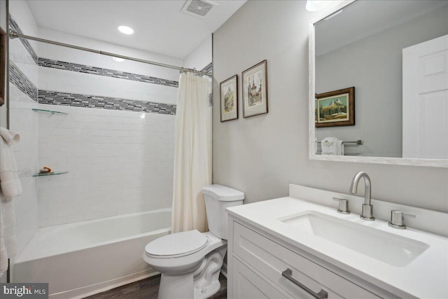 full bathroom with vanity, toilet, wood-type flooring, and shower / bath combo