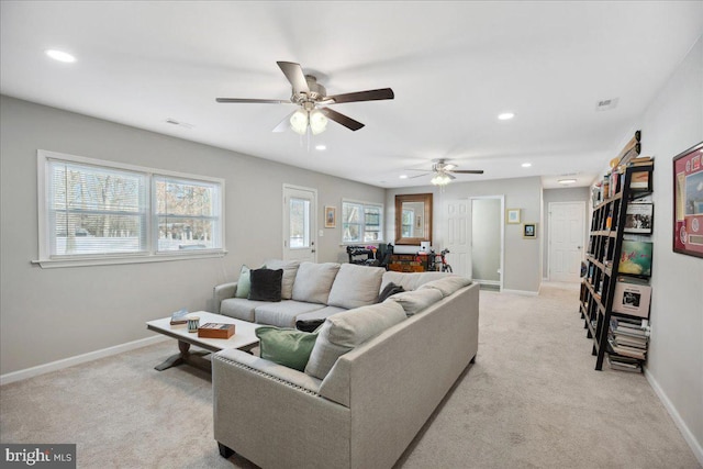 living room featuring light carpet and ceiling fan