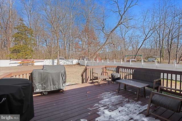 wooden deck featuring a grill