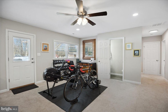 workout room featuring ceiling fan and carpet flooring