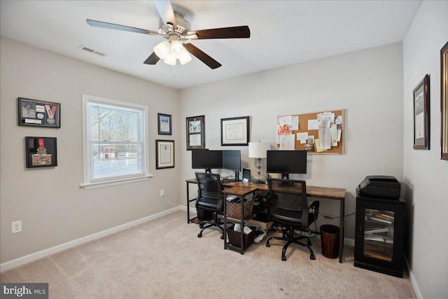 office space with ceiling fan and light carpet