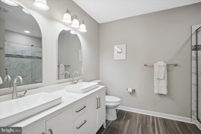 bathroom with walk in shower, wood-type flooring, toilet, and vanity