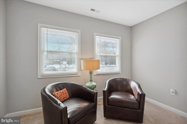 living area featuring light carpet