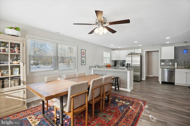 dining room with ceiling fan, dark hardwood / wood-style floors, and sink