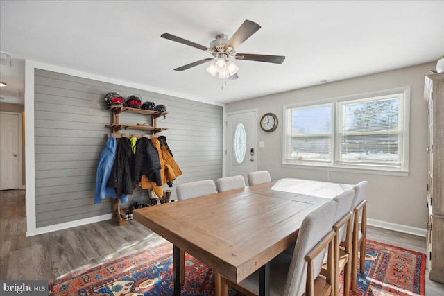 dining space with dark wood-type flooring and ceiling fan