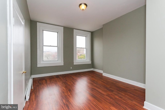 1812 Mcculloh St, Baltimore, MD 21217 - unfurnished room featuring a baseboard radiator, dark wood-style flooring, and baseboards