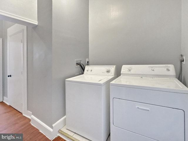 1812 Mcculloh St, Baltimore, MD 21217 - washroom featuring washer and dryer, light wood finished floors, and baseboards
