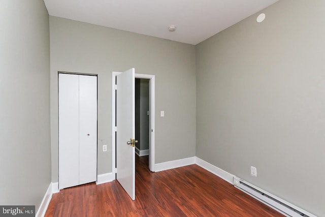 1812 Mcculloh St, Baltimore, MD 21217 - unfurnished bedroom featuring a baseboard radiator, wood finished floors, baseboards, and a closet