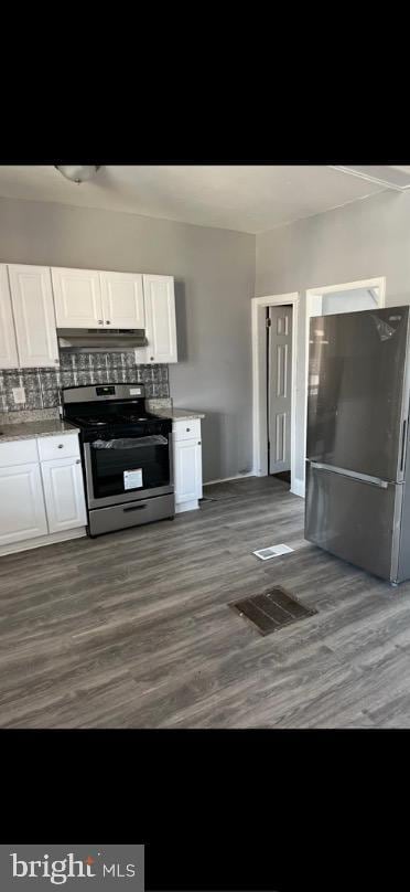 kitchen with white cabinetry, stainless steel appliances, and dark hardwood / wood-style flooring