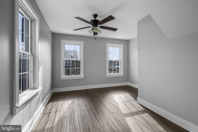 spare room with hardwood / wood-style flooring and ceiling fan