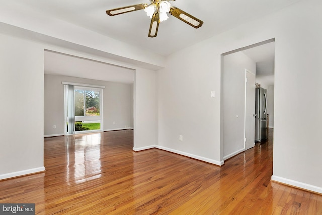 11501 Piney Lodge Rd, North Potomac, MD 20878 - spare room with hardwood / wood-style floors, a ceiling fan, and baseboards