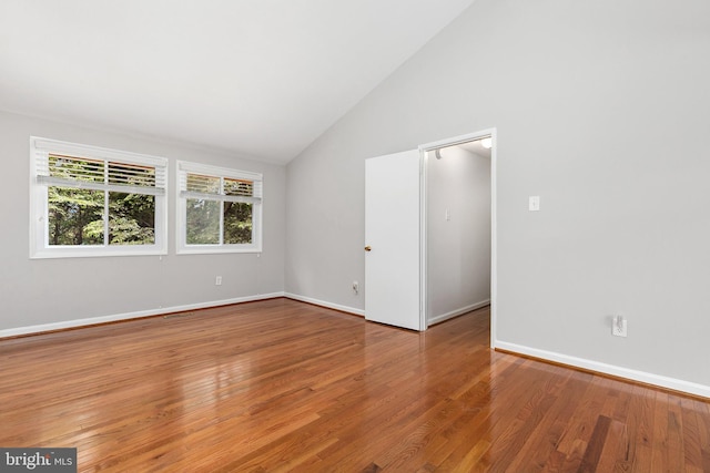 11501 Piney Lodge Rd, North Potomac, MD 20878 - spare room featuring wood finished floors, baseboards, and high vaulted ceiling