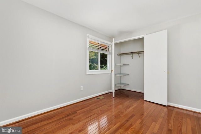 11501 Piney Lodge Rd, North Potomac, MD 20878 - unfurnished bedroom featuring hardwood / wood-style floors, a closet, and baseboards