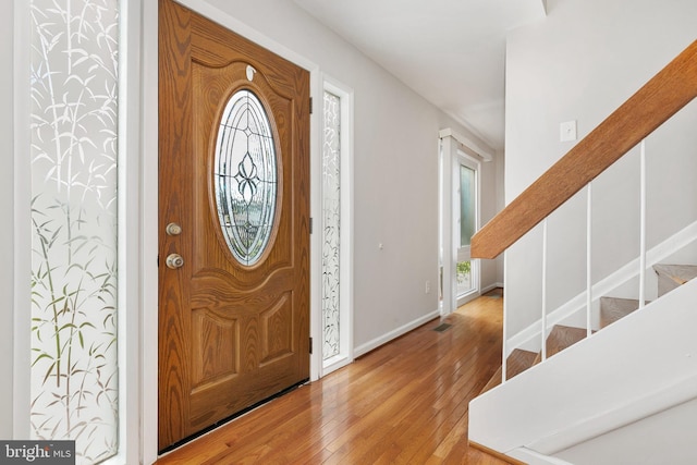 11501 Piney Lodge Rd, North Potomac, MD 20878 - foyer featuring light wood-style flooring, baseboards, and stairs
