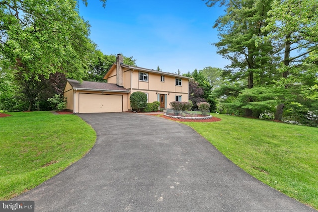 11501 Piney Lodge Rd, North Potomac, MD 20878 - view of front of home featuring a chimney, a front lawn, driveway, a garage, and stucco siding