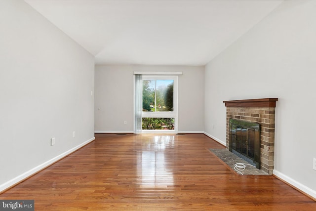 11501 Piney Lodge Rd, North Potomac, MD 20878 - unfurnished living room featuring a fireplace, wood finished floors, and baseboards