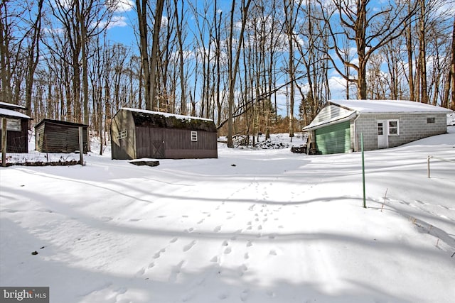 snowy yard with an outdoor structure