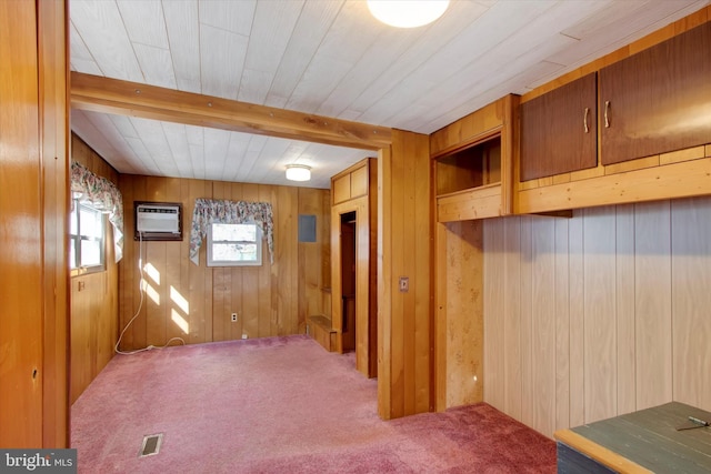 interior space featuring wooden walls, carpet, and an AC wall unit