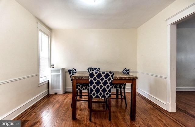 dining room featuring plenty of natural light and dark hardwood / wood-style floors