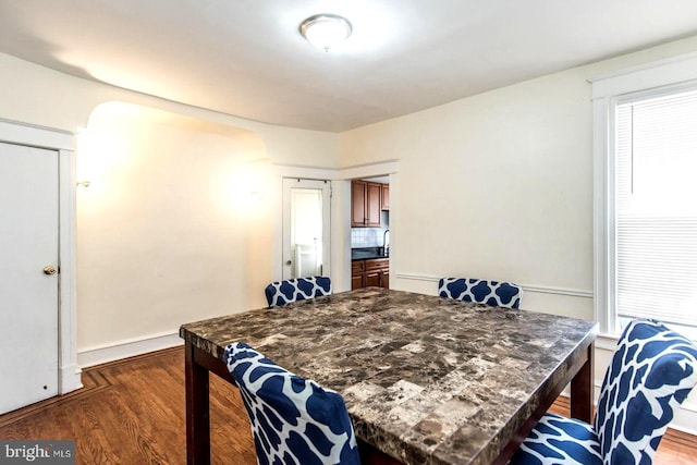 dining room with dark wood-type flooring