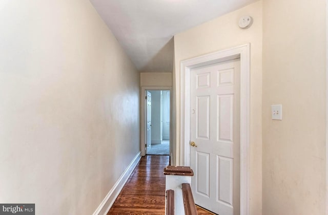 corridor with dark hardwood / wood-style flooring