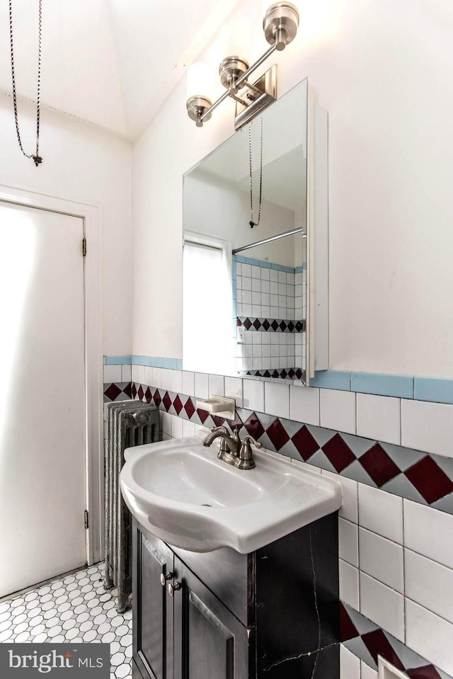 bathroom featuring tile walls and vanity