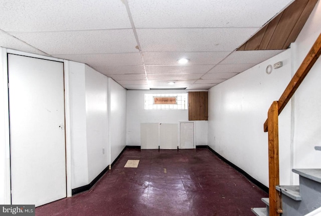 basement with a paneled ceiling