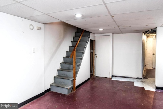 basement with a paneled ceiling