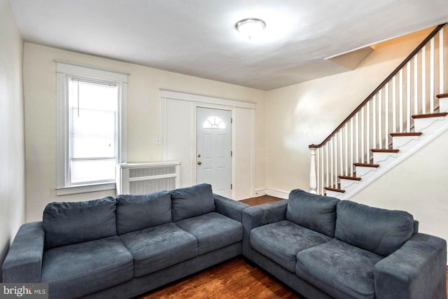 living room with dark hardwood / wood-style floors and a wall mounted air conditioner