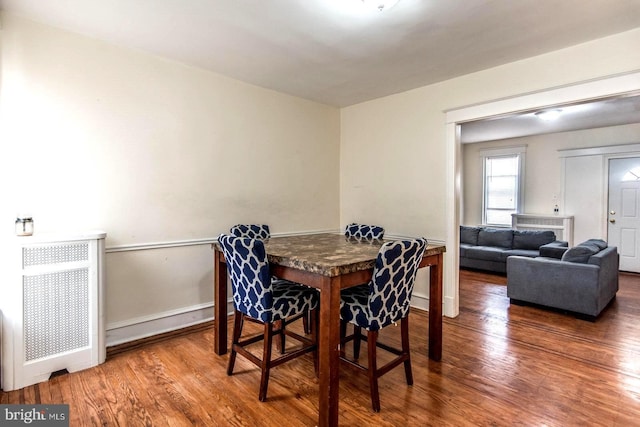 dining space with hardwood / wood-style flooring