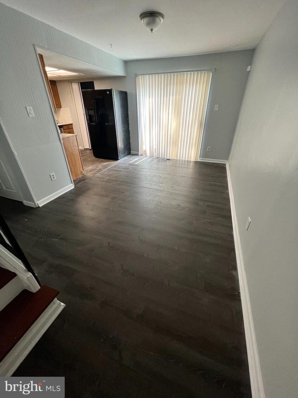 unfurnished living room with dark hardwood / wood-style floors