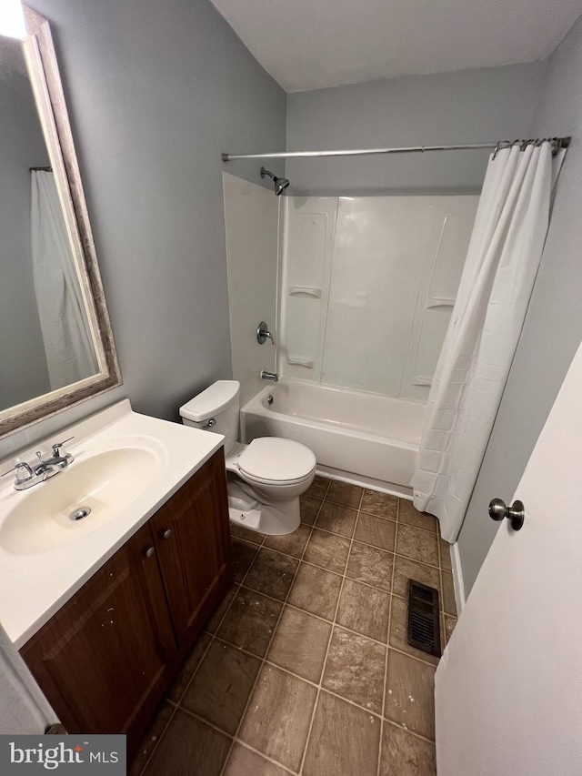 full bathroom featuring toilet, vanity, and shower / bath combo with shower curtain