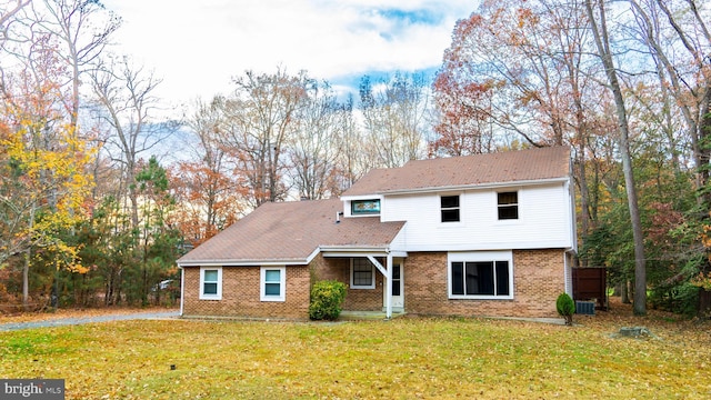 front of property featuring a front lawn and central air condition unit