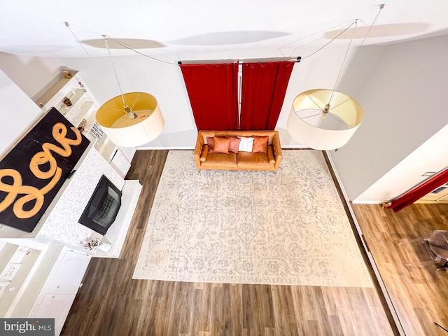 unfurnished living room featuring hardwood / wood-style flooring and a large fireplace