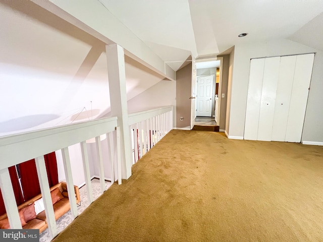 additional living space with lofted ceiling and carpet flooring