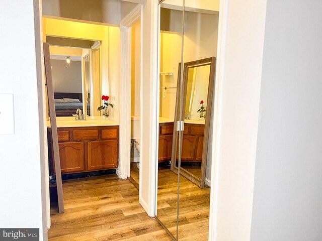 hallway featuring sink and light wood-type flooring