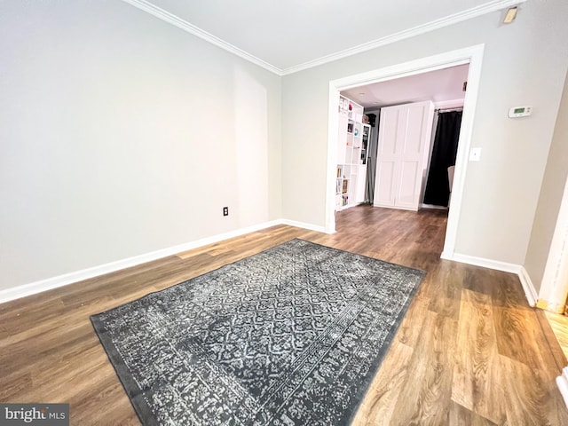 spare room featuring ornamental molding and wood-type flooring