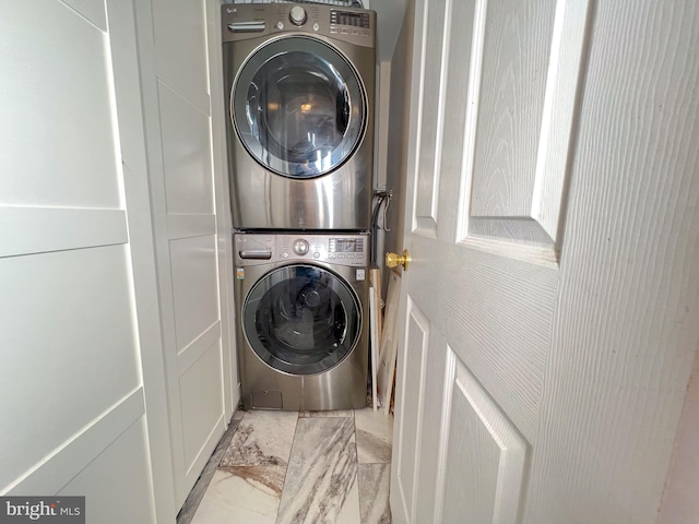 laundry area featuring stacked washing maching and dryer