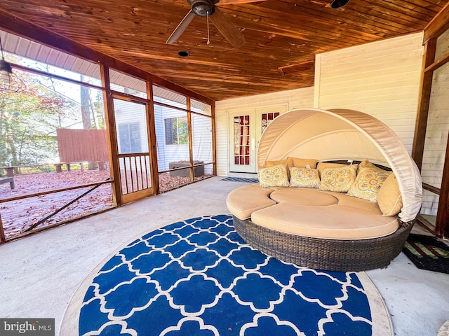 sunroom with ceiling fan and wooden ceiling