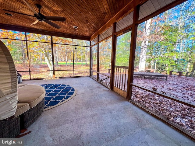 unfurnished sunroom featuring wooden ceiling and ceiling fan