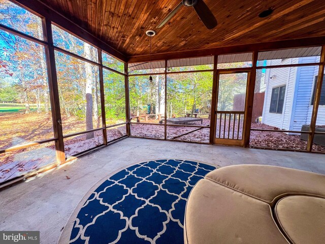 unfurnished sunroom with wooden ceiling and ceiling fan