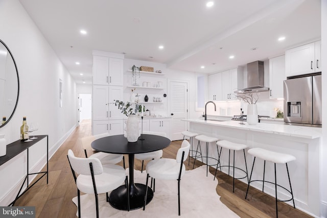 dining space featuring sink and light hardwood / wood-style flooring