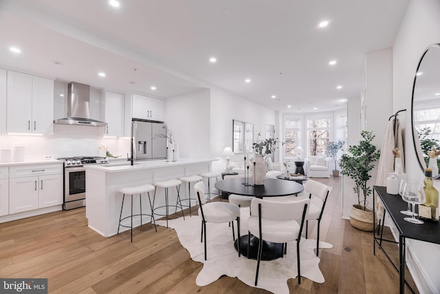 dining space featuring light hardwood / wood-style floors and a healthy amount of sunlight