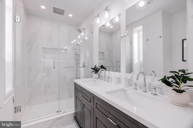 bathroom with an enclosed shower and vanity