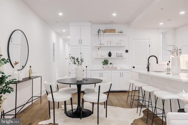 dining room featuring sink and light hardwood / wood-style flooring