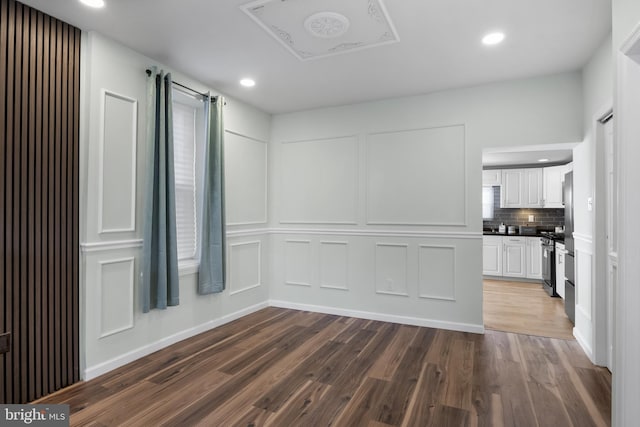 spare room featuring dark hardwood / wood-style flooring